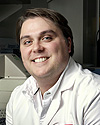 A photograph of Erik Tokar, Ph.D.