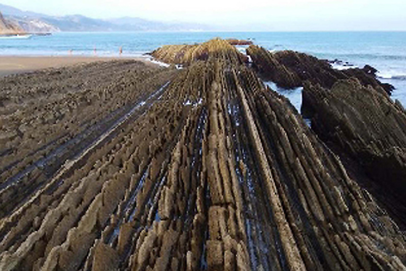Outcrop of flysch (sequences of marl, shale, and sandstone) illustrating near-vertical bedding plan fractures in Zumaia, Spain. (Photo used with permission from B.G. Angel.