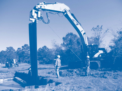 Figure 2. An excavator equipped with a vibrator hammer was used to install and remove the steel sheets along lengths of the Stoller Chemical SR-PRB.