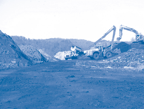 Figure 3. Backhoes segregate excavated wastes as it is screened and crushed at the Sharon Steel Corporation-Fairmont Coke Works Superfund site.