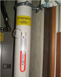 Interior plumbing of the typical sub-slab depressurization systems, including a U-tube manometer providing real-time measurements.