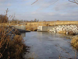 Figure 3. 12-foot-wide drop structure controlled by a five-foot-wide stop-log system at the Murdock Groundwater Plume site.